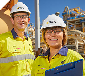 People in hard hats holding a clipboard