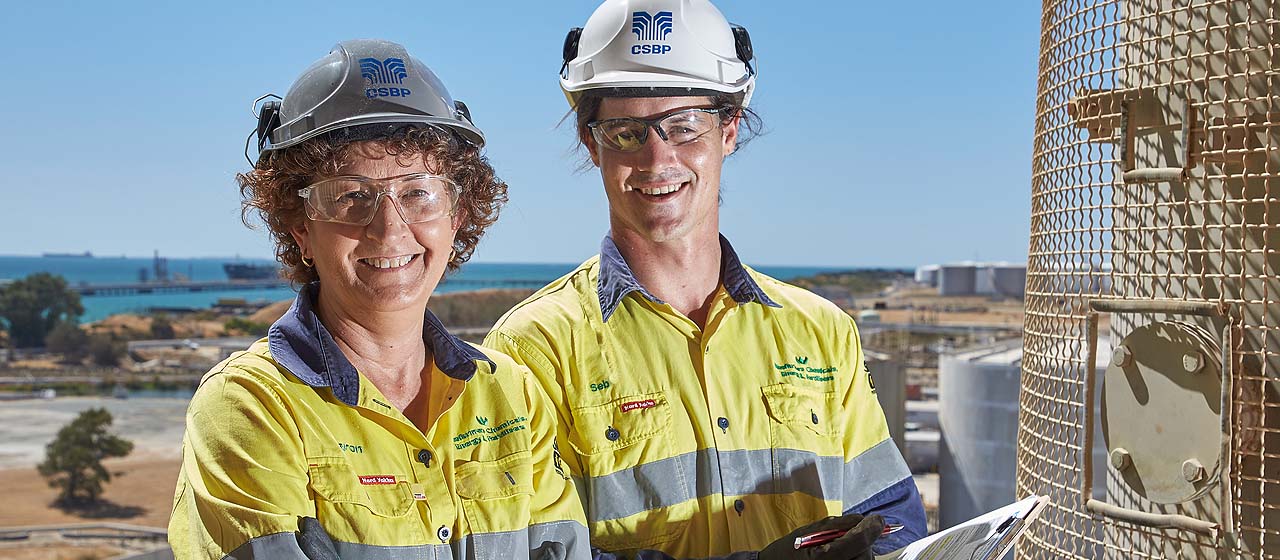 CSBP employees in hard hats up tower