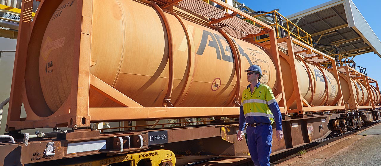 Man walking past sodium cyanide train